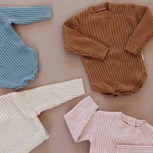 bamboo sweater onesies in pink, cream, grey, and orange